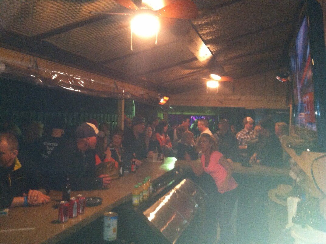 Guests along the bar under the tin ceiling at Gig's Place